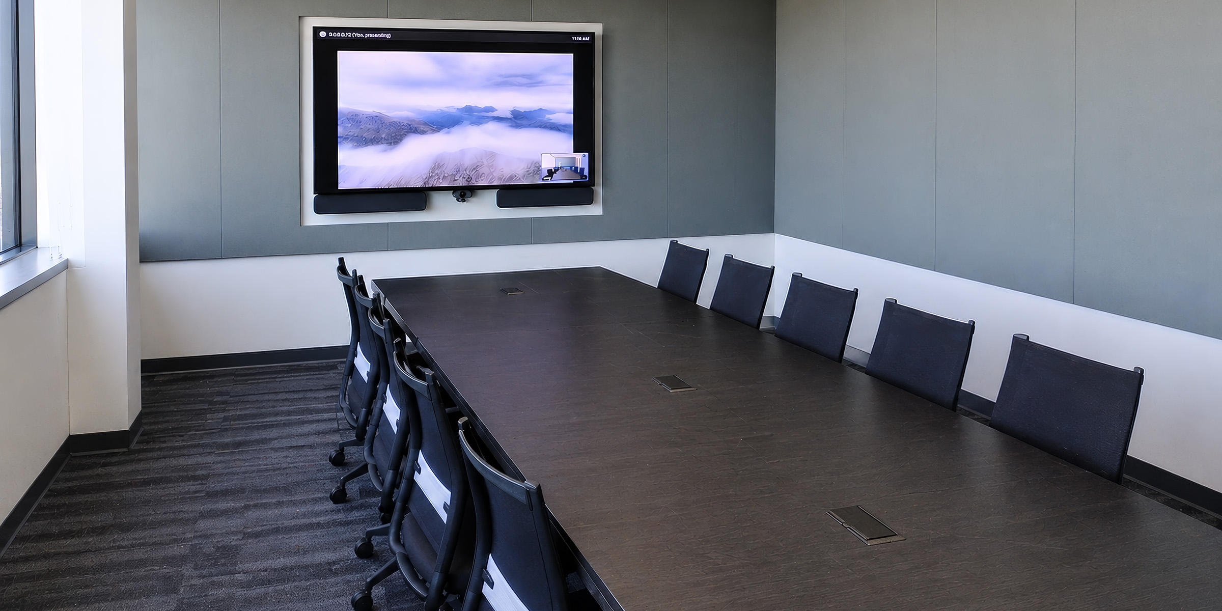 Enterprise meeting room with integrated AV systems and hybrid collaboration tools for production teams