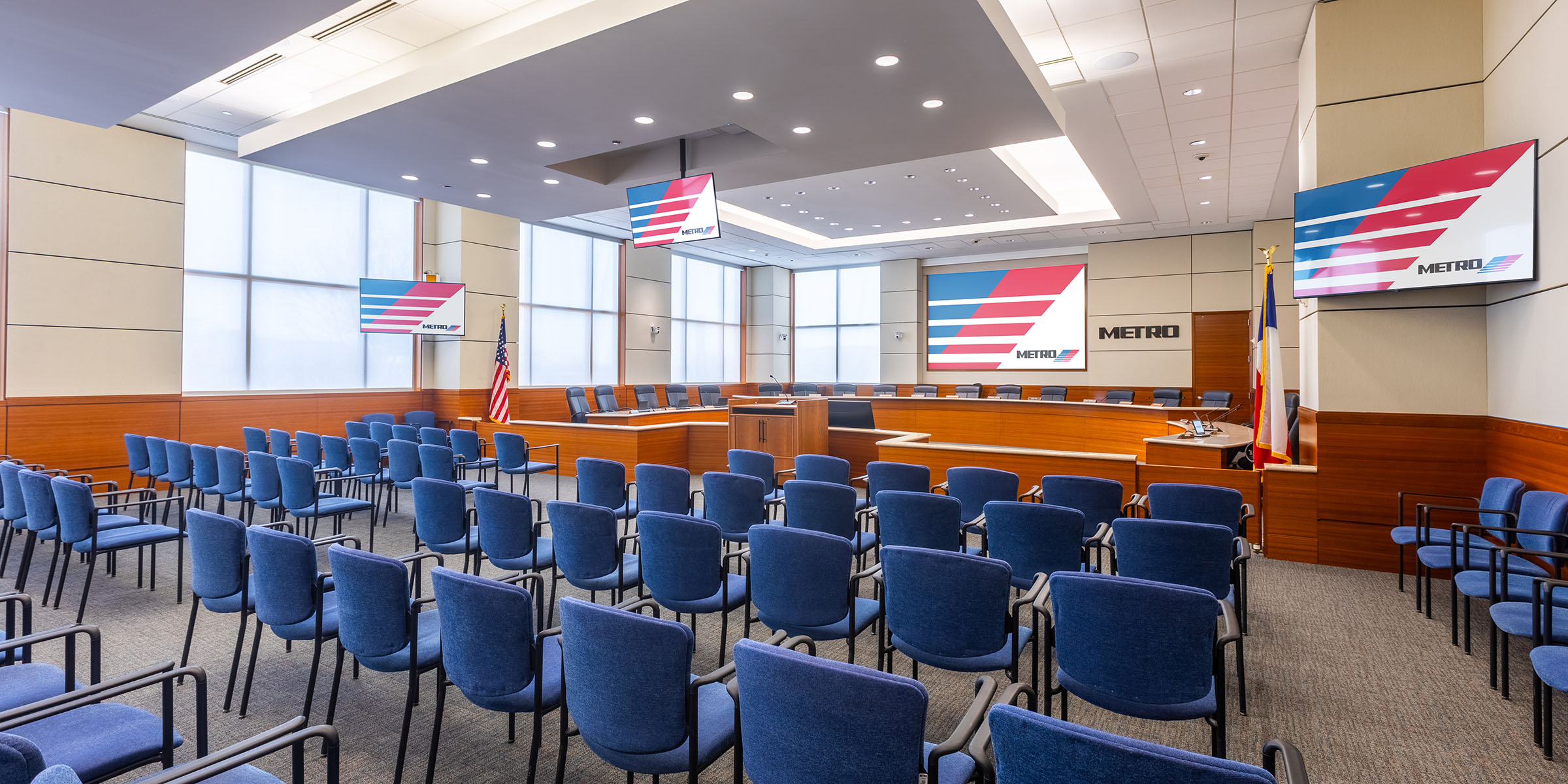 boardroom AV installation with conference microphones, presentation displays, and broadcast-ready meeting infrastructure.